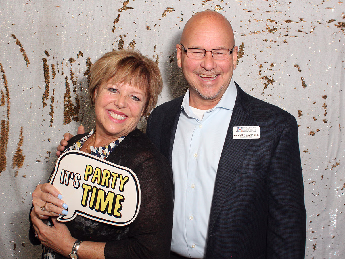 Founder of Photo Magic Events, Deb Newman and a friend using a photo booth rental