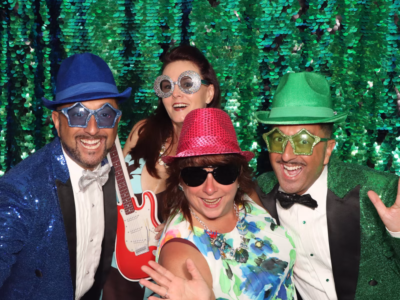 Entertainers and attendees of a fundraising event enjoying a moment in their photo booth rental from Photo Magic Events