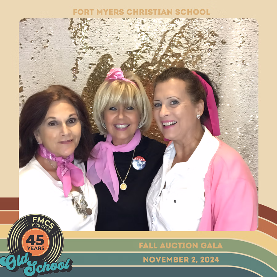 Teachers dressed in vintage attire using the DIY Magic Photo Booth Rental at the Fall Auction Gala