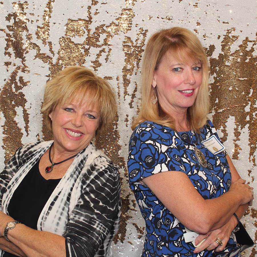 Founder of Photo Magic Events, Deb Newman and a friend using a photo booth rental