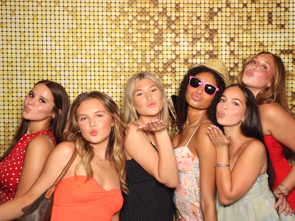 Group of girls using the Infinite Magic Photo Booth at a graduation party
